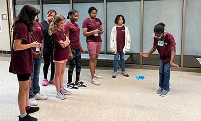 A group of middle school girls fly a drone at Bits and Bytes camp.