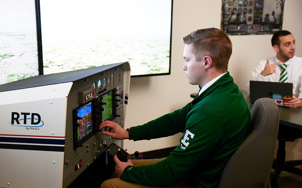 A student using a flight simulator in the aviation classroom