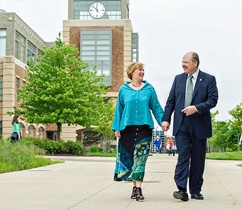 EMU President James Smith and his wife, Connie Ruhl-Smith walking on campus.