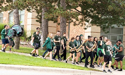 EMU marching band walking the city streets 