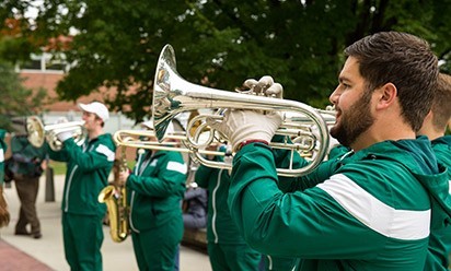 EMU marching band walking the city streets 