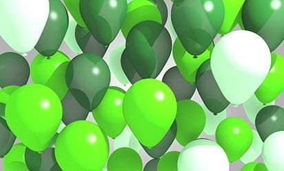 many green birthday balloons