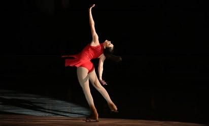 Skater Heaney in a red dress performing on the ice.