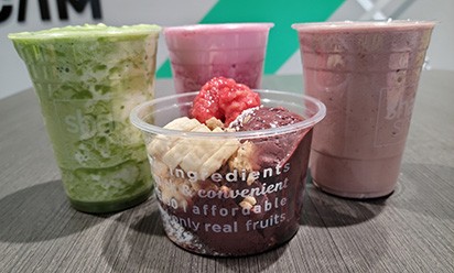 Some of the healthy shakes and an acai bowl are displayed on a table at the new Shake Smart inside the Rec/IM.