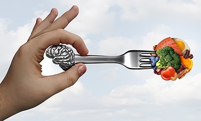 Concept illustration of a hand holding a fork full of foods, symbolizing the connection between taste signals and the brain
