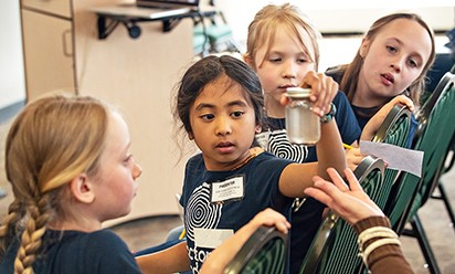 Young students participate in a hands-on, STEM-based activity.