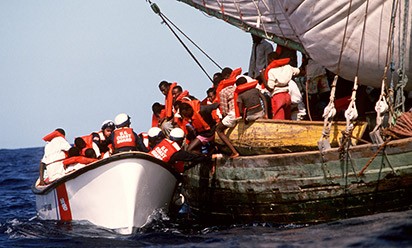 Haitian refugees board a Coast Guard boat.