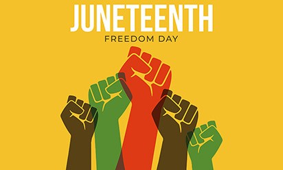 Raised fists of red, green and brown on a yellow background representing Juneteenth.