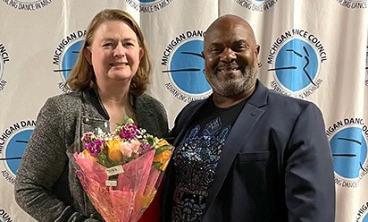 Sherry Wilkinson holds a bouquet next to Michigan Dance Council President, Greg Patterson