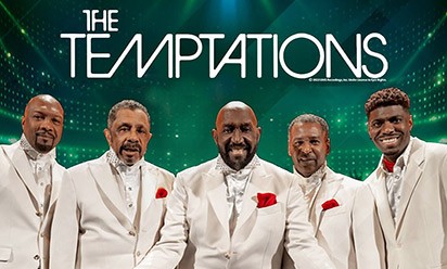 The Temptations vocal group on a green lighted stage background