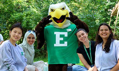 Swoop and students outside on campus on a sunny day.