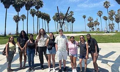 McNair Scholars at the UCLA Conference amid sun and palm trees.