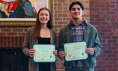 Chloe Hibbler and Isaiah Garcia holding their award certificates.