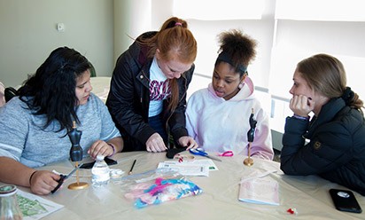 Young women work on a project at the Digital Divas event.