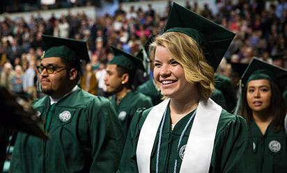 A happy graduate at commencement.