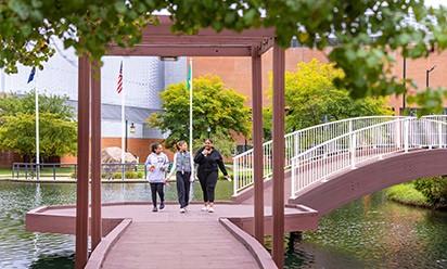 Students walk across the bridge at University Park.