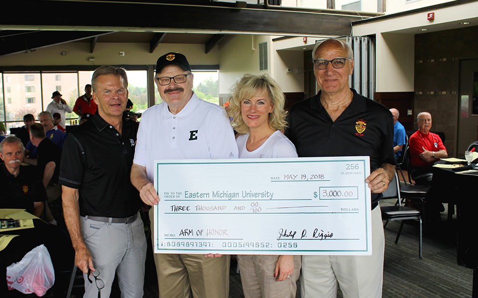 President Smith and others pose with a large ceremonial check from Arm of Honor.