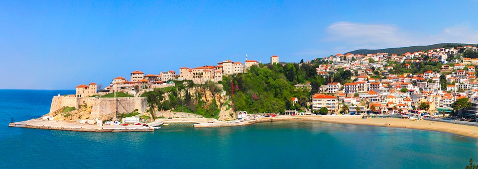 A panoramic image of Ulcinj, Montenegro showing the buildings on the shoreline.