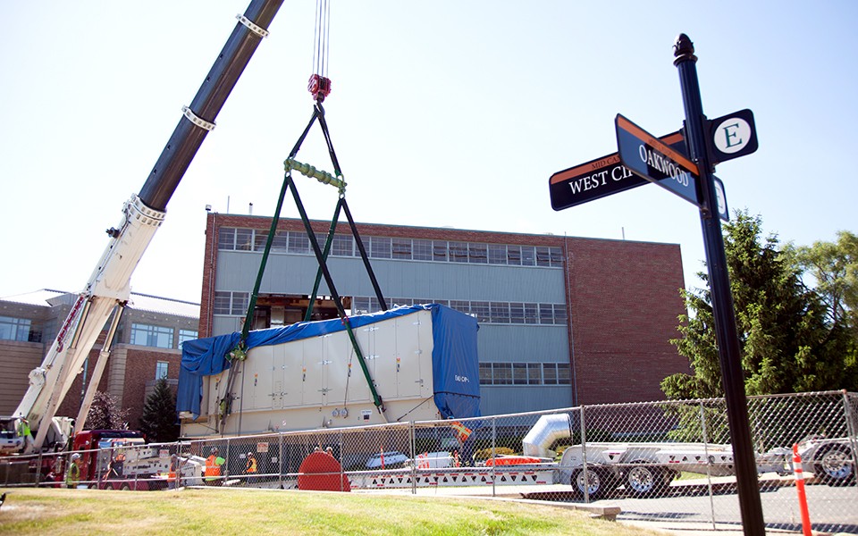 The turbine for the Energy Center is moved into the building with a giant crane.