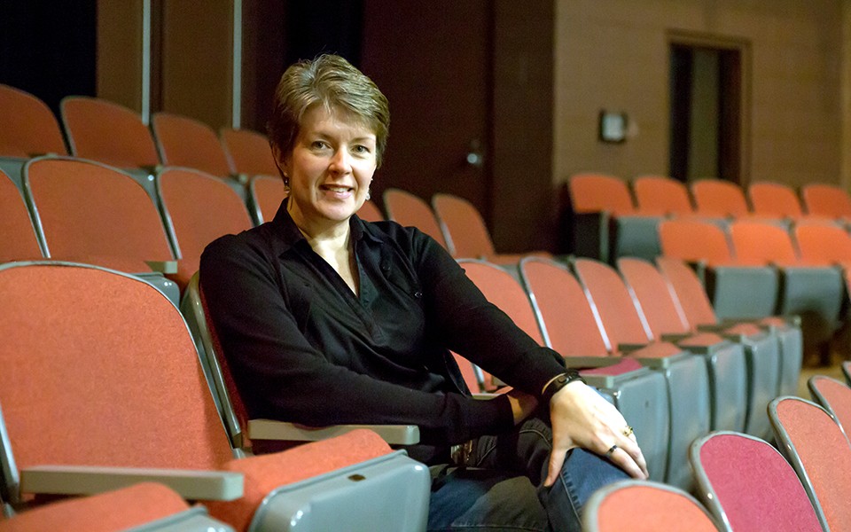 Pam Cardell sits in the EMU seats at Quirk-Sponberg Theatre.