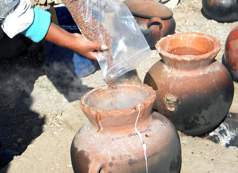 Ingredients being poured into a Peruvian ceramic pot.