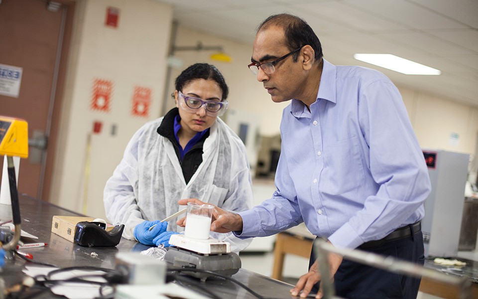 Vijay Mannari in coatings lab with student