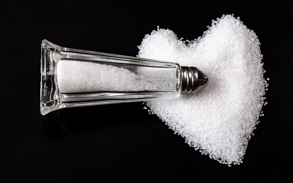 Salt shaker lying in a heart-shaped pile of salt