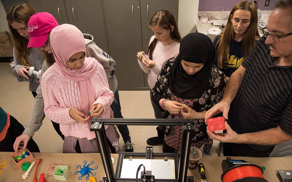 Young girls work on a STEM project with an EMU instructor at the 2018 Digital Divas event.