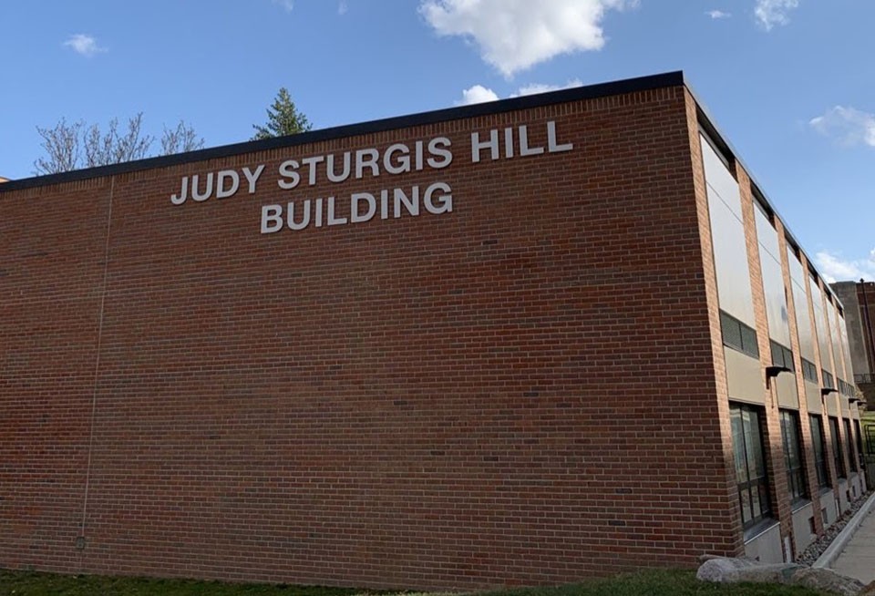 red brick side of building with sign letters that read judy sturgis hill building