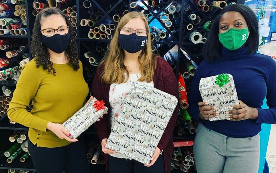 SHRM officers hold wrapped holiday gifts