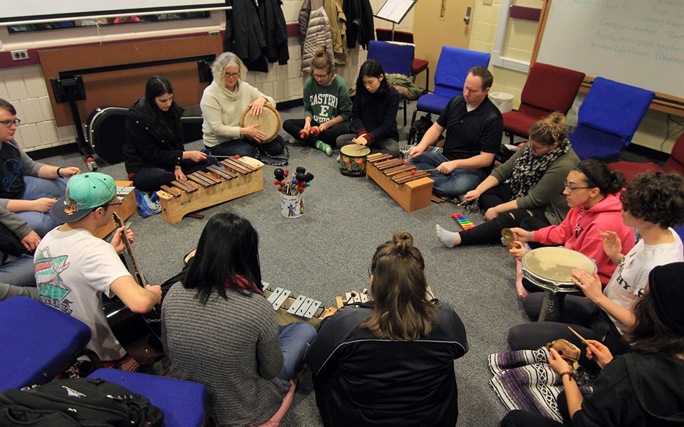 File photo of a students playing instruments in a circle in music therapy class