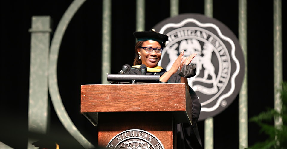 Regent Dr. Jessie Kimbrough Marshall at the podium at a commencement ceremony.