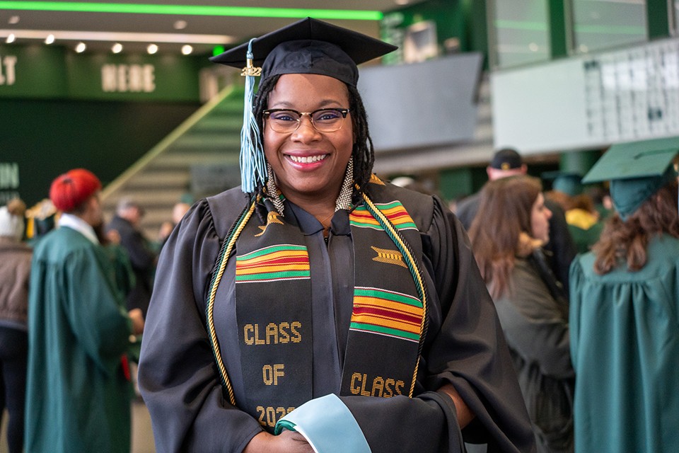 Quiana Davis-Lewis is dressed in her masters's degree cap and gown at the Gervin Center Winter 2022 Commencement Ceremony.