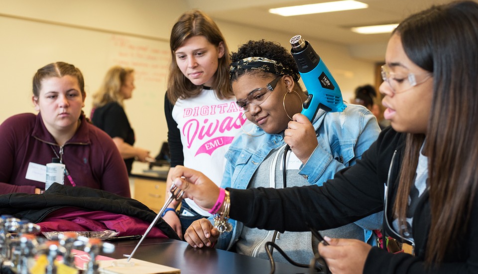 Middle School girls participate in a STEM experiment at a Digital Divas event 