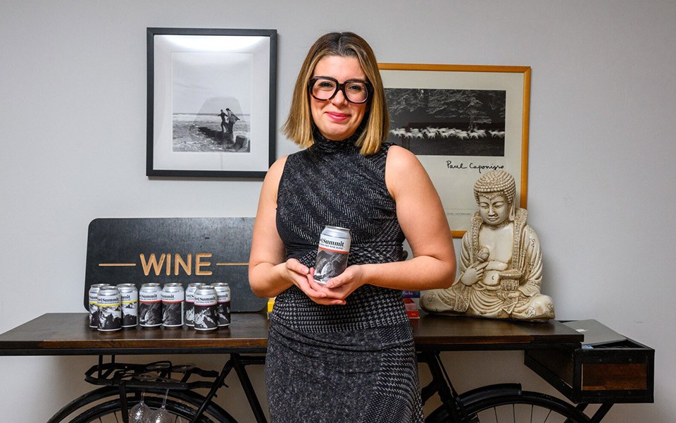 Emily Dabish Yahkind in her home office with her environmentally-conscious SolSummit wines.
