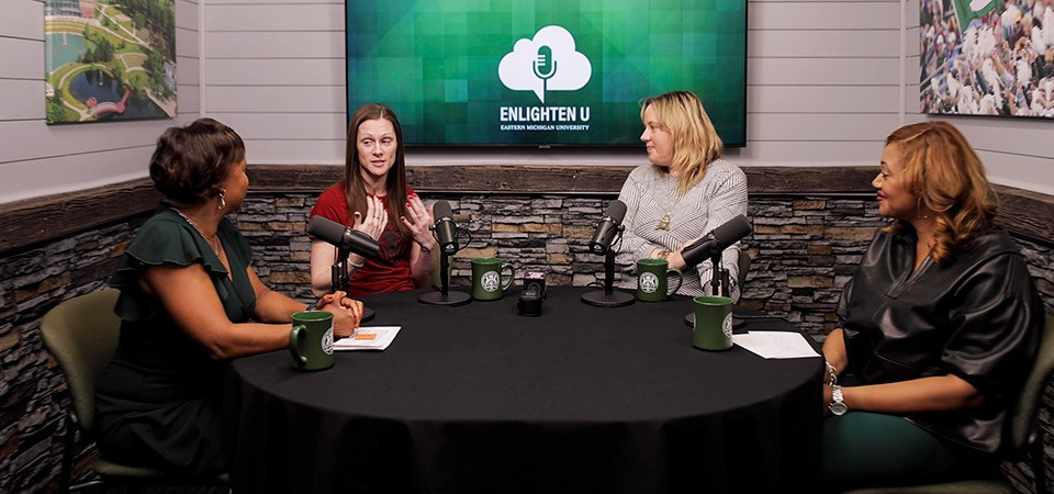 Lolita Cummings, Chrissie Zavicar, Brenna Breshears, and Melissa Thrasher seated around a table on the Enlighten U podcast set.