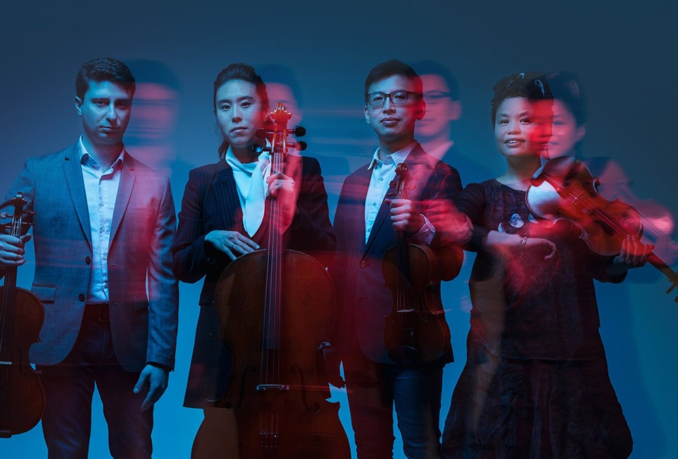 Formosa Quartet with their instruments in an artistic photo in red and blue