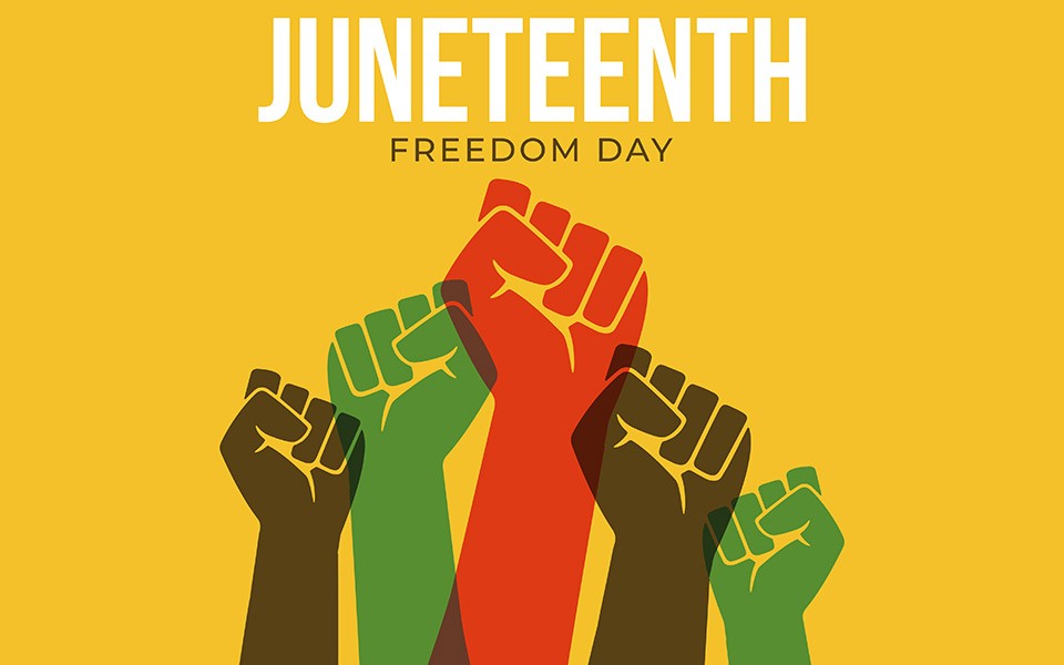 Raised fists of red, green and brown on a yellow background representing Juneteenth.
