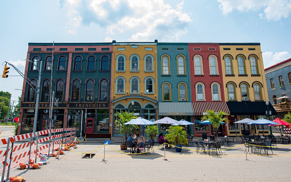 Depot Town on a sunny day with streets blocked for an event with outdoor tables.