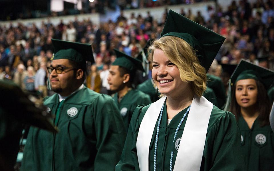 A happy graduate at commencement.