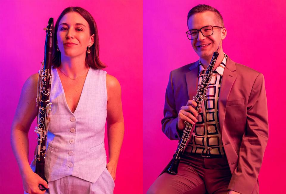 Kari Landry and Tim Gocklin posing with their instruments against a bright pink background