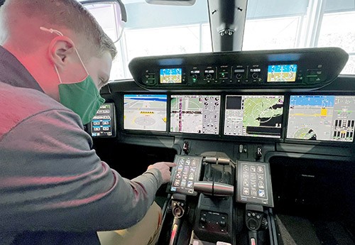 EMU student in the cockpit of jet at Gulfstream Aerospace