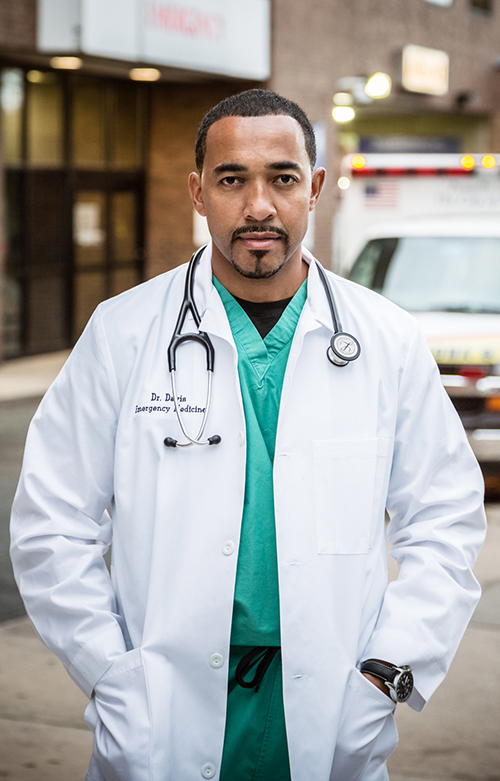 Dr. Sampson Davis wearing white coat with stethoscope around his neck