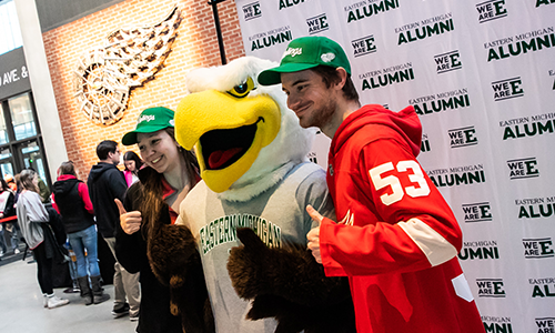 Red Wings fans at the EMU Night game take a photo with Swoop