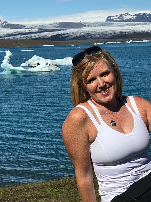 Michelle Crumm in Iceland with icebergs in the background.