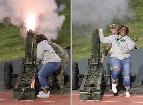 Regent Eunice Jeffries lights a cannon with an EMU ROTC cadet